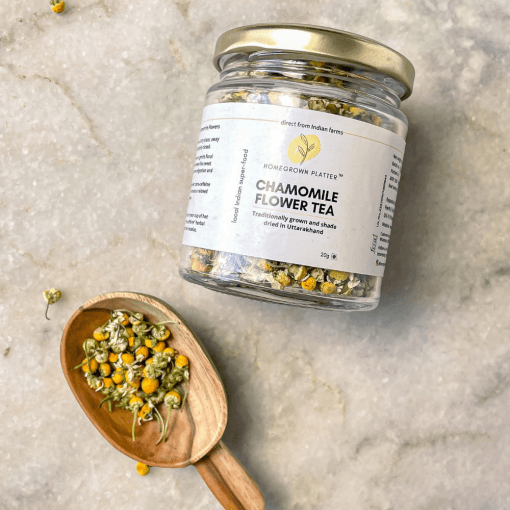 Loose chamomile flowers and a jar of chamomile